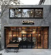 Modern stone coffee shop exterior nestled in local garden landscaping